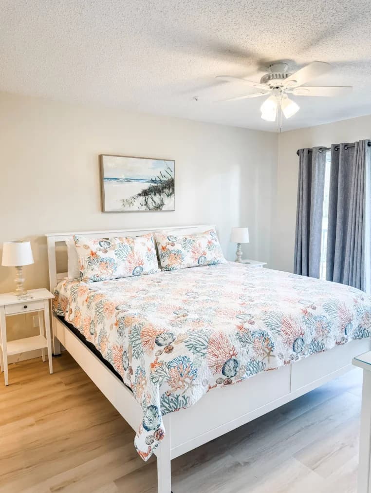 Primary bedroom features a comfortable, king size bed.